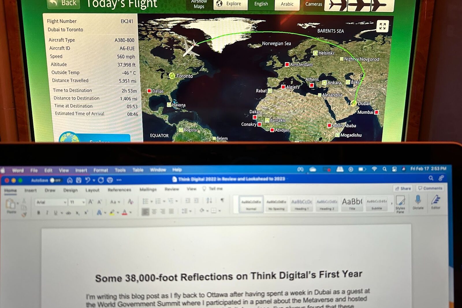 Airplane map in the background showing trip from Dubai to Toronto. In foreground laptop screen with word document open with the title of this blog post: Some 38,000-foot Reflections on Think Digital's First Year
